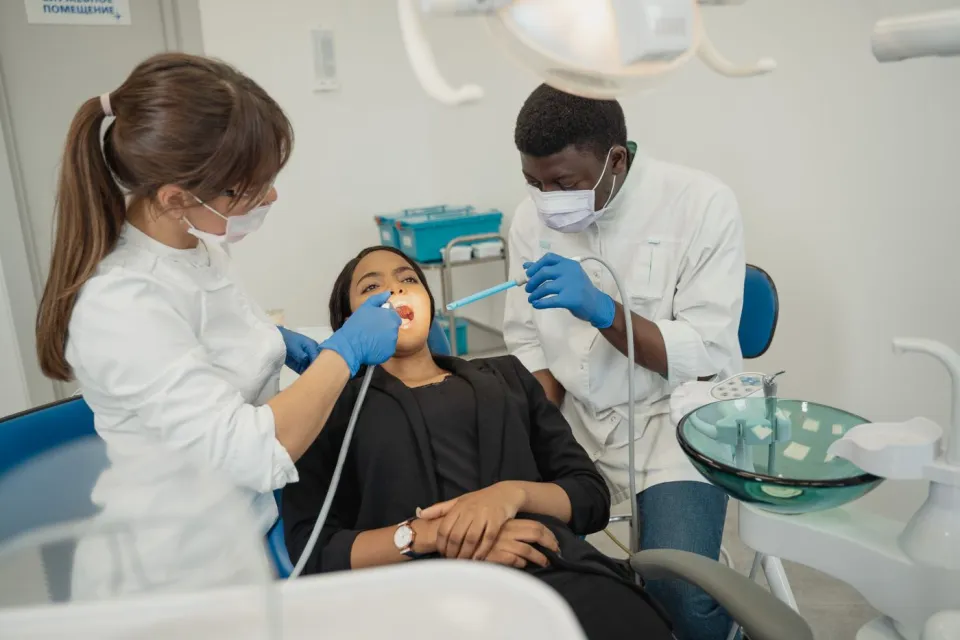 A dentist speaking with a patient during an appointment