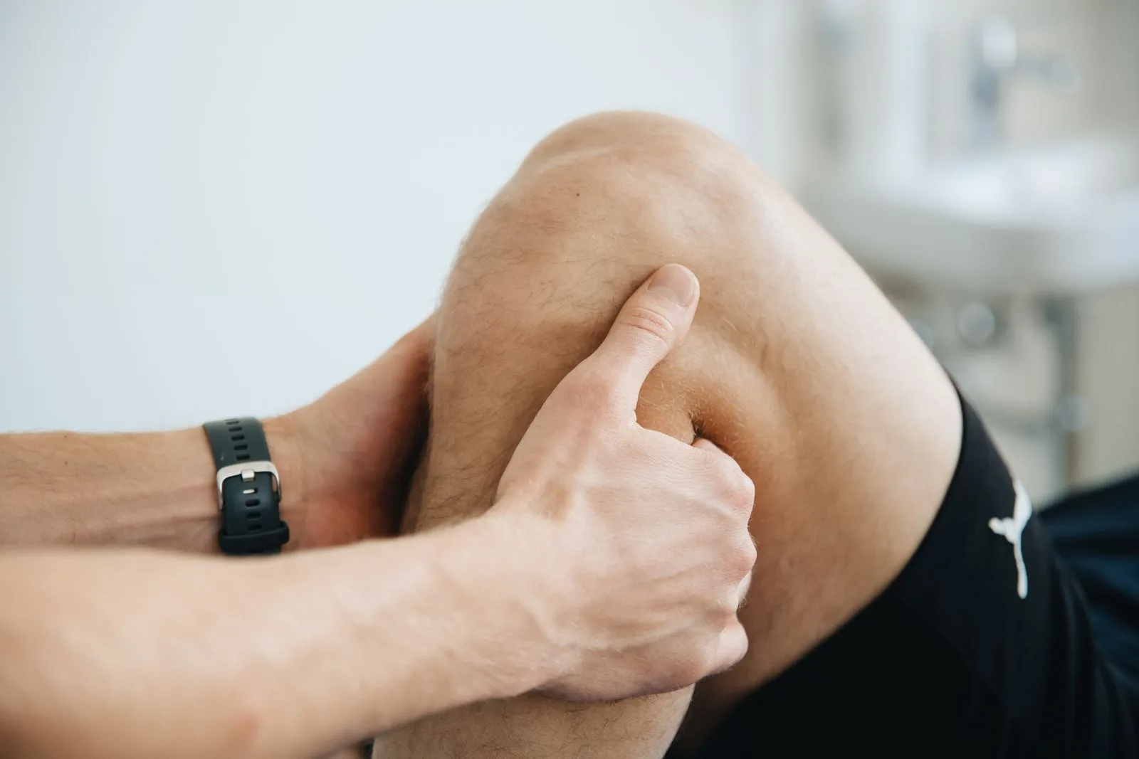 A clinician examining a patient's knee