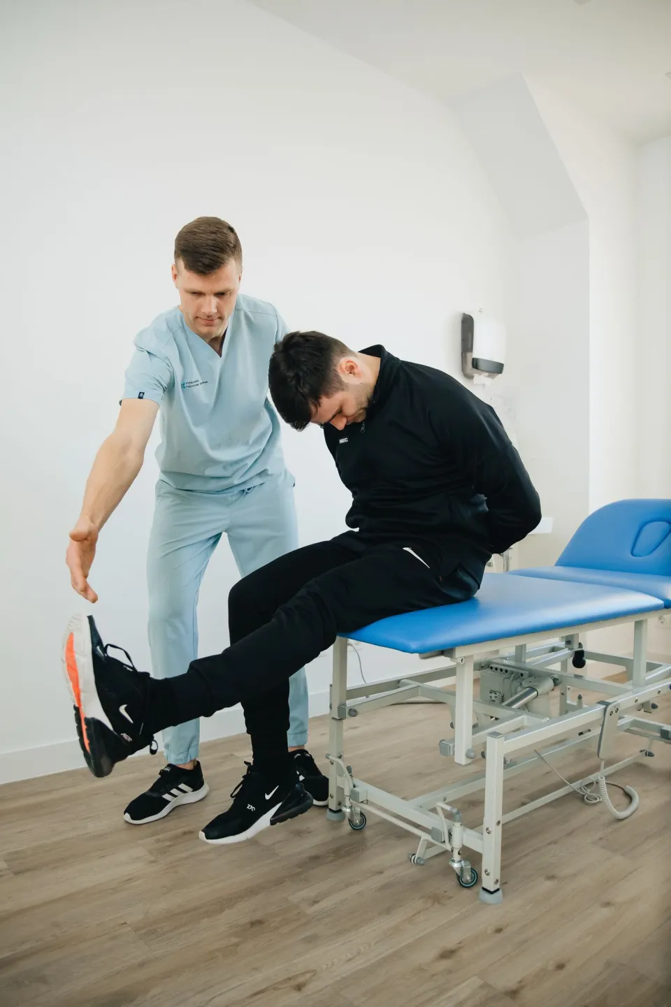 A physical therapist guiding a patient through rehabilitation