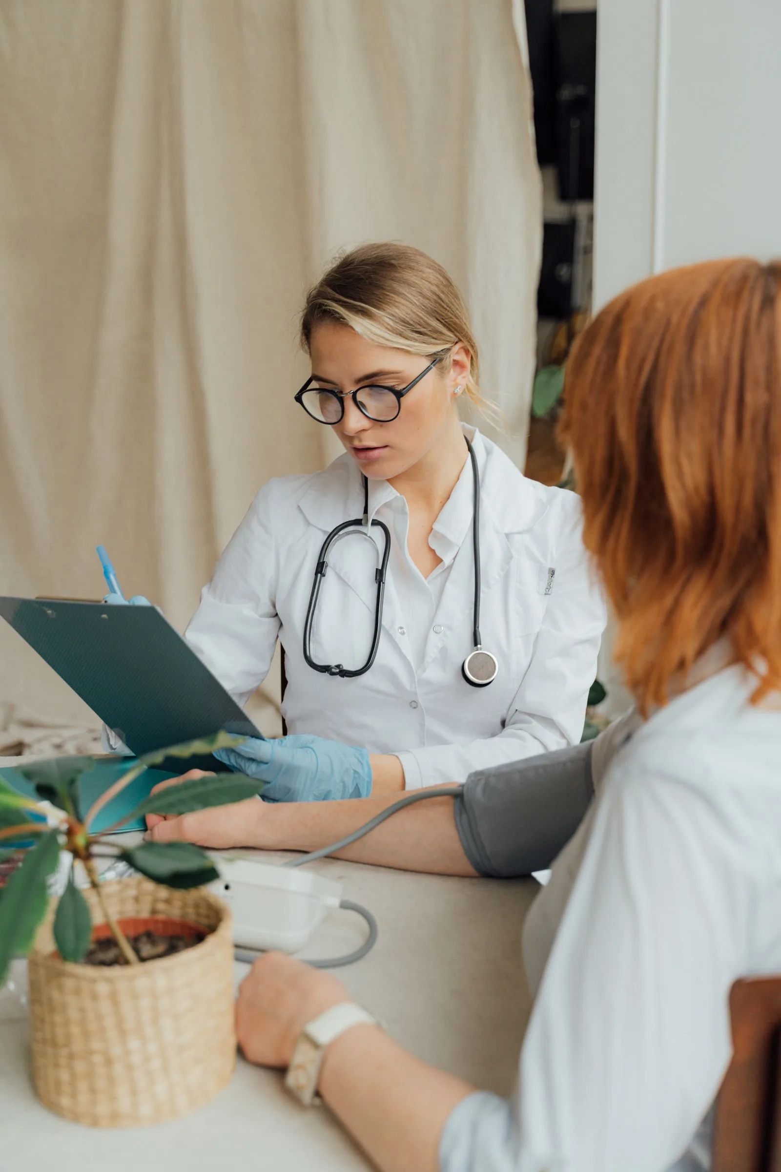 A physician consulting with a woman in a clinical setting